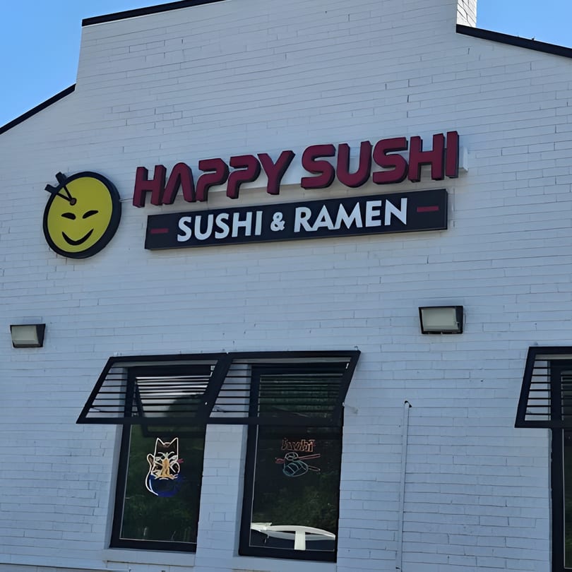 Happy Sushi restaurant exterior with a yellow smiley face logo and "Sushi & Ramen" sign.